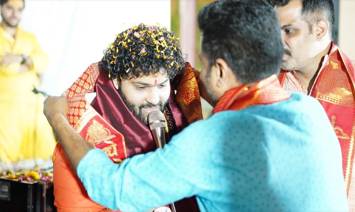 Pt. Govinda Sharma being honoured with a stole while singing